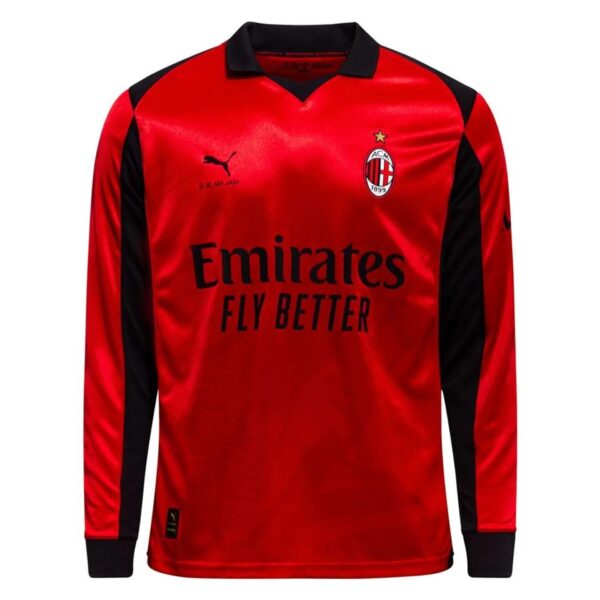 Red AC Milan jersey with black sleeves, crest on the left chest, and Emirates sponsor text across front with a gold star above the badge.