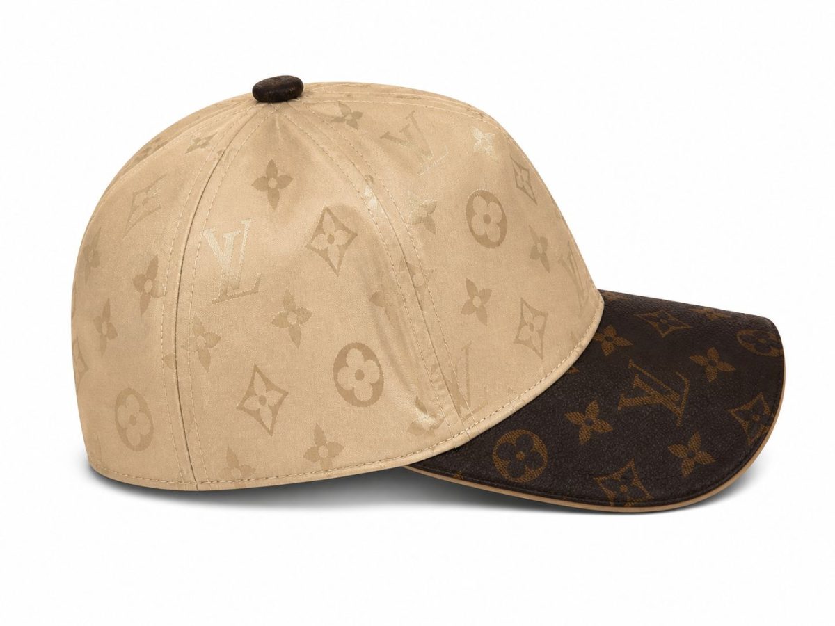 Beige Louis Vuitton monogram cap with a dark brown bill and small top button on white background.