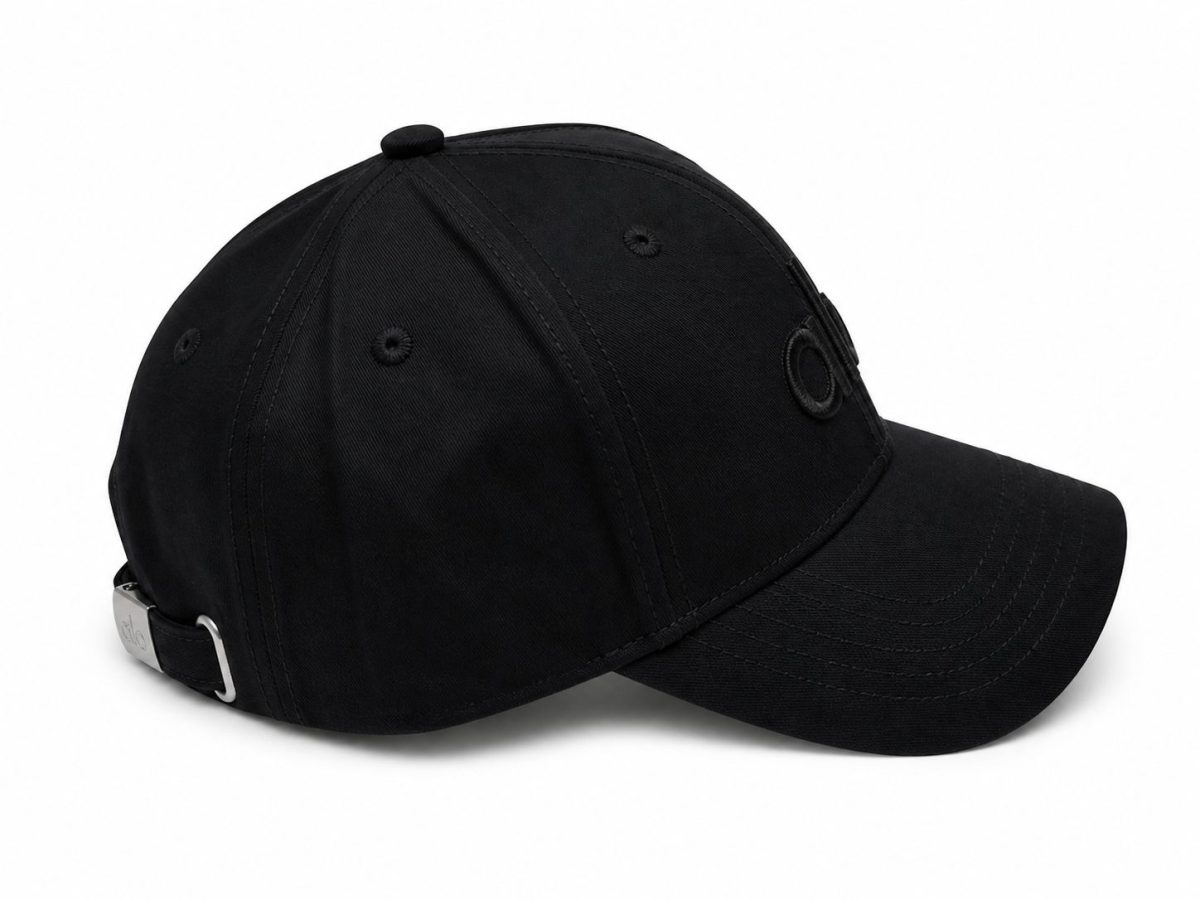 Black baseball cap with an adjustable metal buckle at the back and curved brim, shown in side view.