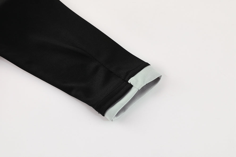 70ed9ea4 | UAE SPORT STORE Close-up of a black sleeve with a light gray cuff folded back