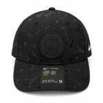 Black baseball cap featuring a raised Paris Saint-Germain crest on the front with subtle Eiffel Tower and star prints throughout.