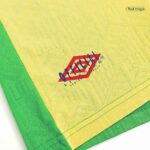 Close-up of yellow fabric with a green edge and a blue-red 'Official Licensed Product' logo printed on it.
