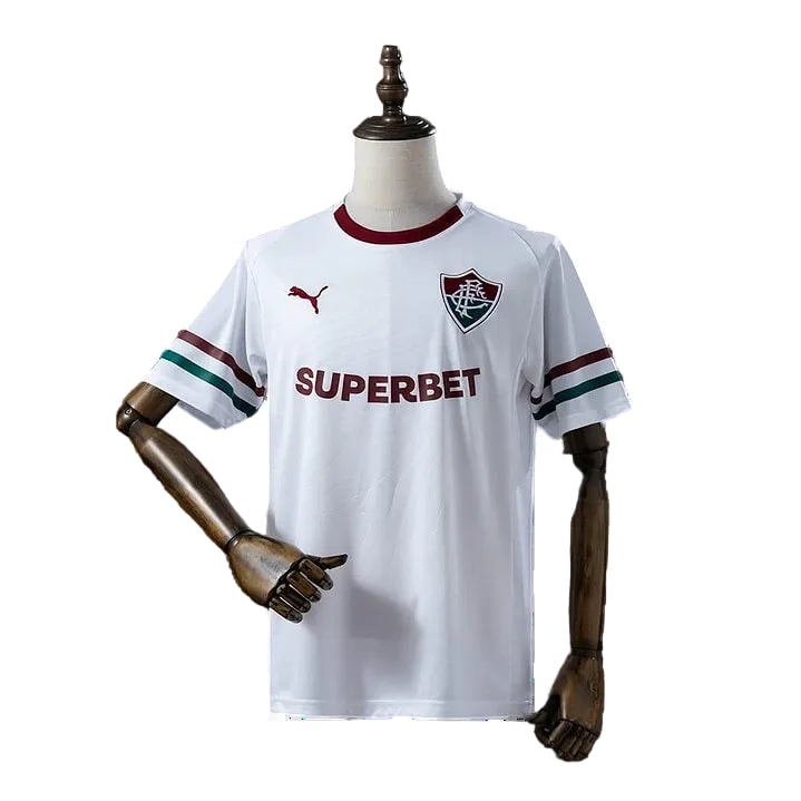 719 | UAE SPORT STORE White sports jersey on a mannequin with maroon collar, team crest on the left chest, 'SUPERBET' across the front, and green/red sleeve stripes.