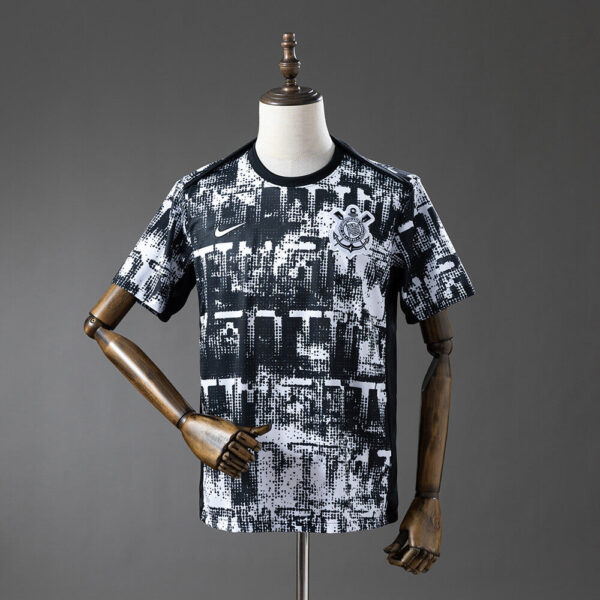 Black and white abstract-patterned soccer jersey on a mannequin, with Nike swoosh and club crest.