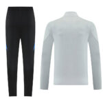Sportswear set: black athletic pants with blue accents paired with a light gray long-sleeve top, shown from behind