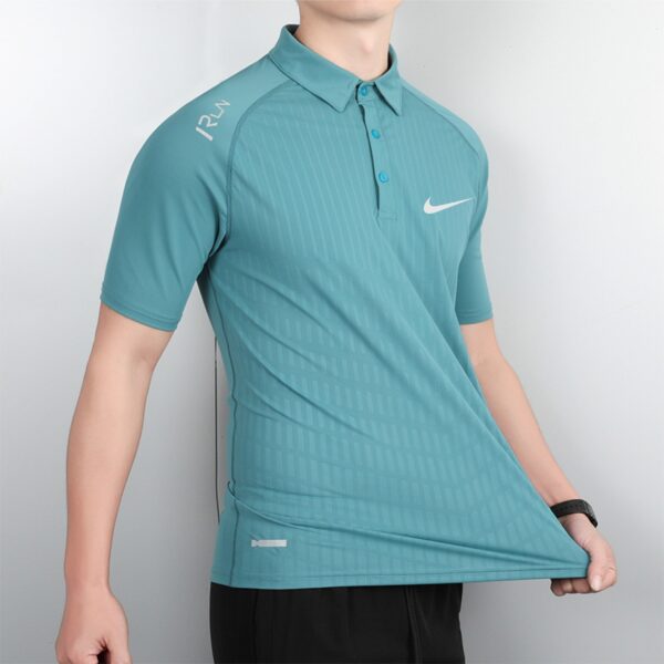 Person wearing a teal Nike polo shirt with faint vertical stripes, shown from the torso up against a neutral background, logo visible on chest.
