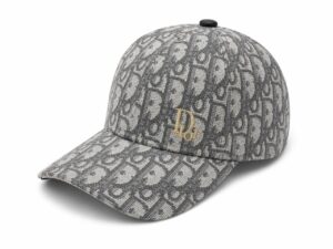 Grey Dior baseball cap with a repeating monogram pattern and a small gold 'Dior' emblem on the front.