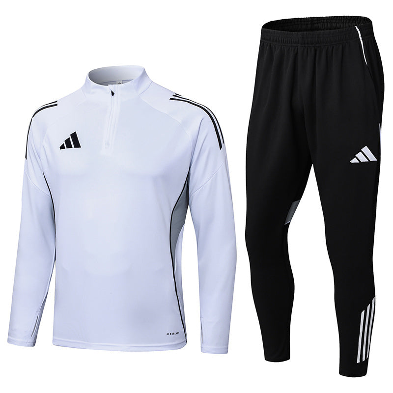 73a91aed White long-sleeve athletic top with zip collar paired with black jogger pants; both feature Adidas branding and side panels.