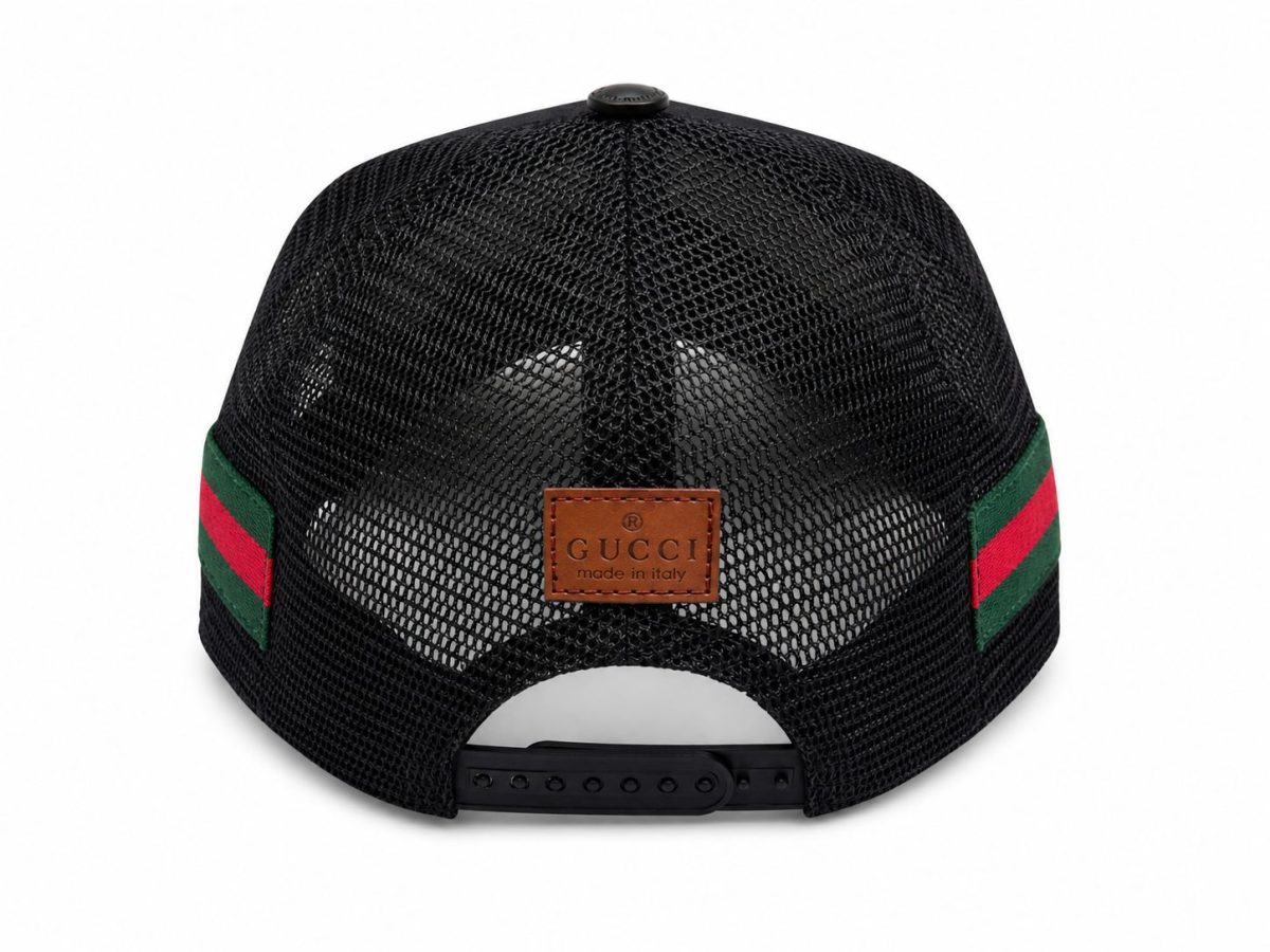 Back view of a black Gucci mesh cap with green and red striped sides, brown leather logo patch, and adjustable strap.