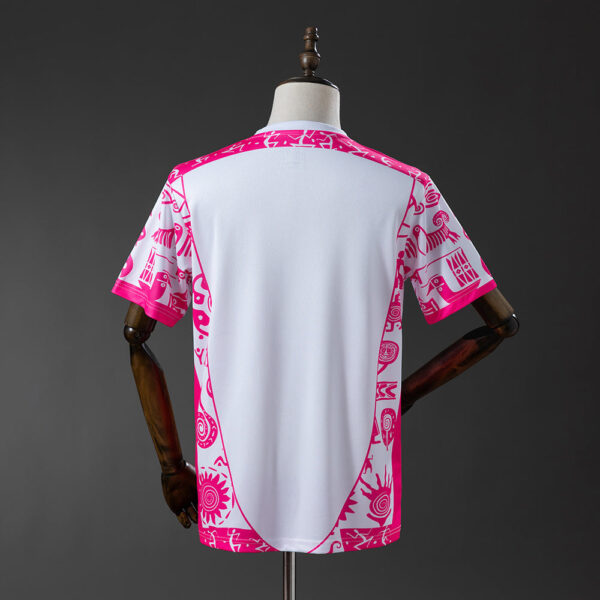 Back view of a white T-shirt with bright pink tribal-pattern trim along the sides and sleeves, displayed on a dress form.