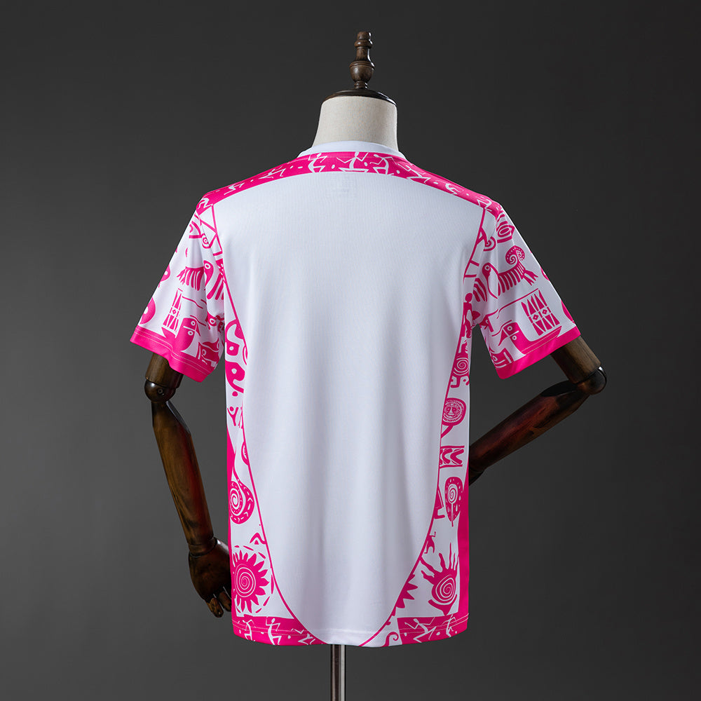 741ca0a6 | UAE SPORT STORE Back view of a white T-shirt with bright pink tribal-pattern trim along the sides and sleeves, displayed on a dress form.