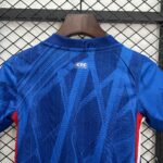 Blue patterned polo shirt on a wooden hanger against a metal diamond lattice background; tag on the collar shows 'CFC'.