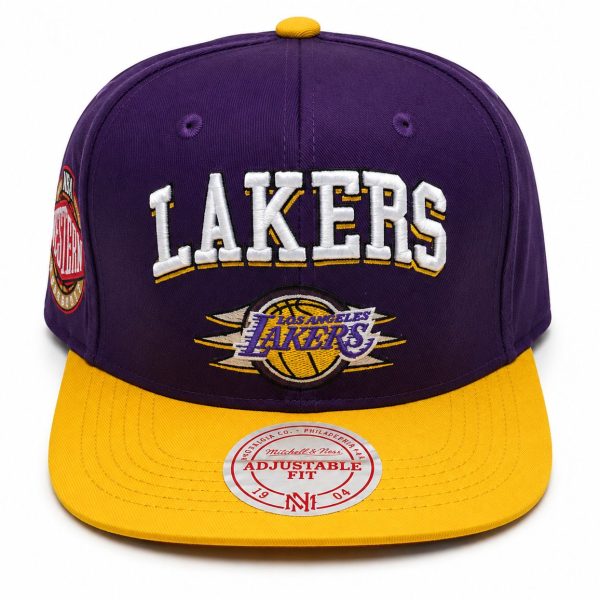 Purple Lakers cap with a yellow brim and embroidered 'LAKERS' on the front