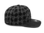 Stylish black monogram cap featuring a prominent logo and intricate pattern, perfect for sports and.