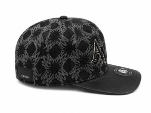 74af1814-2bd9-45ed-bd9b-0f9383d9c121 | UAE SPORT STORE Black patterned baseball cap with an embroidered A logo on the front and an AMIRI label at the back.
