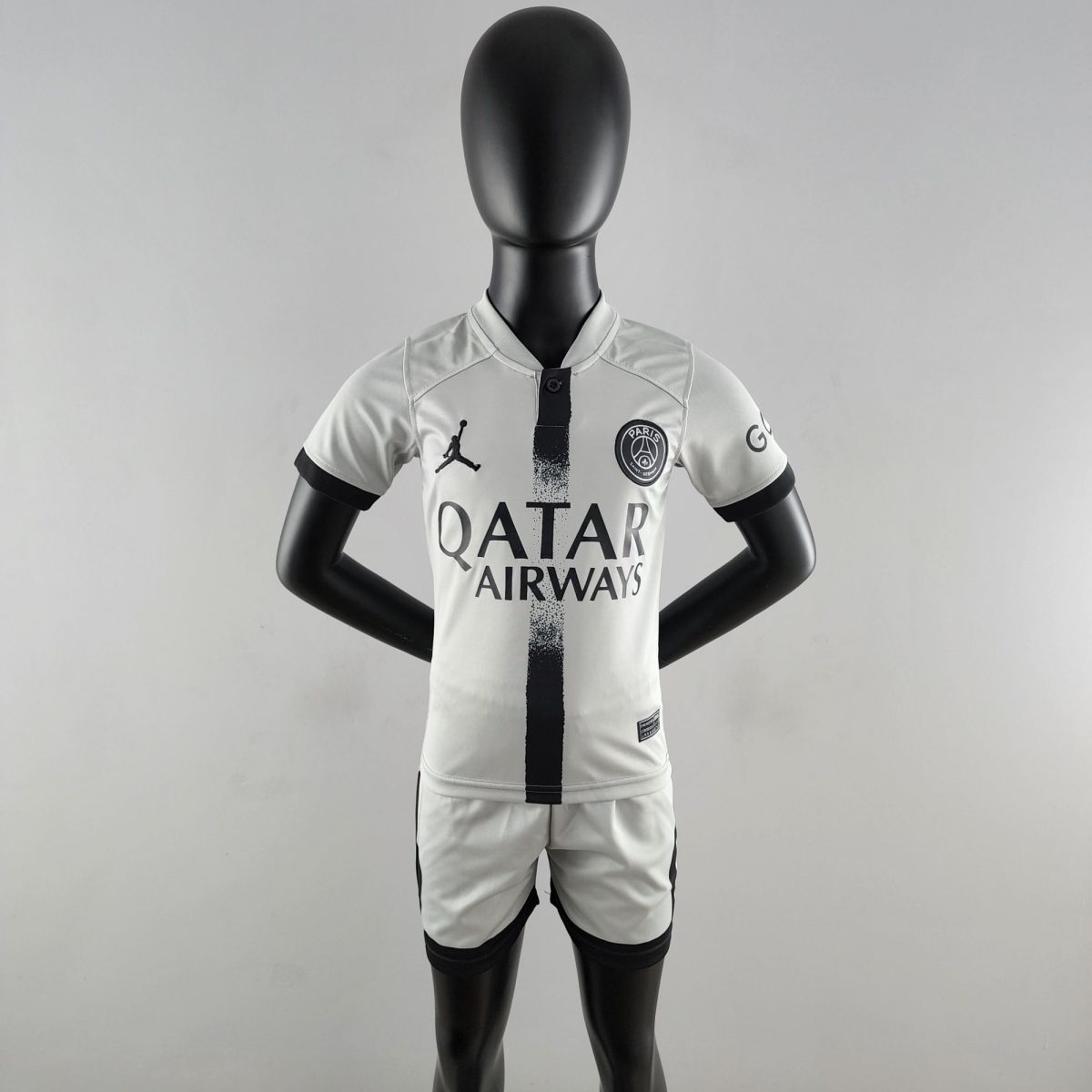 Mannequin wearing a white Paris Saint-Germain football jersey with black detailing and sponsor logos on the chest.