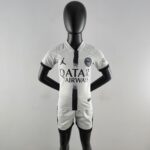 Mannequin wearing a white Paris Saint-Germain football jersey with black detailing and sponsor logos on the chest.