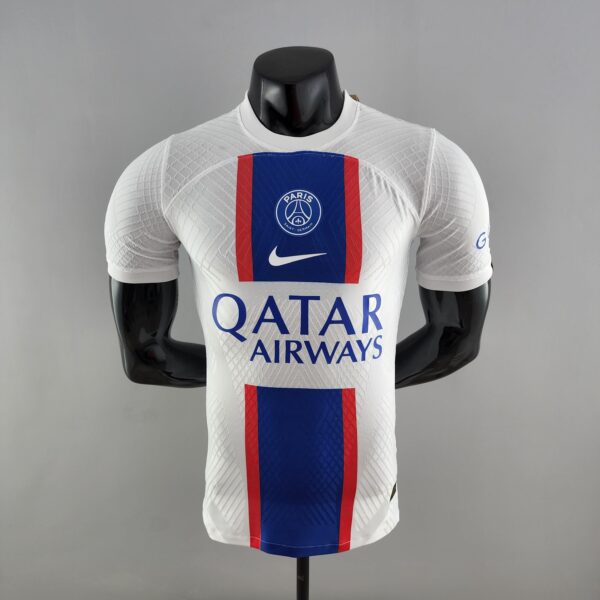 Mannequin wearing a white PSG football jersey with blue and red vertical stripe and Paris crest, Qatar Airways sponsor text visible.