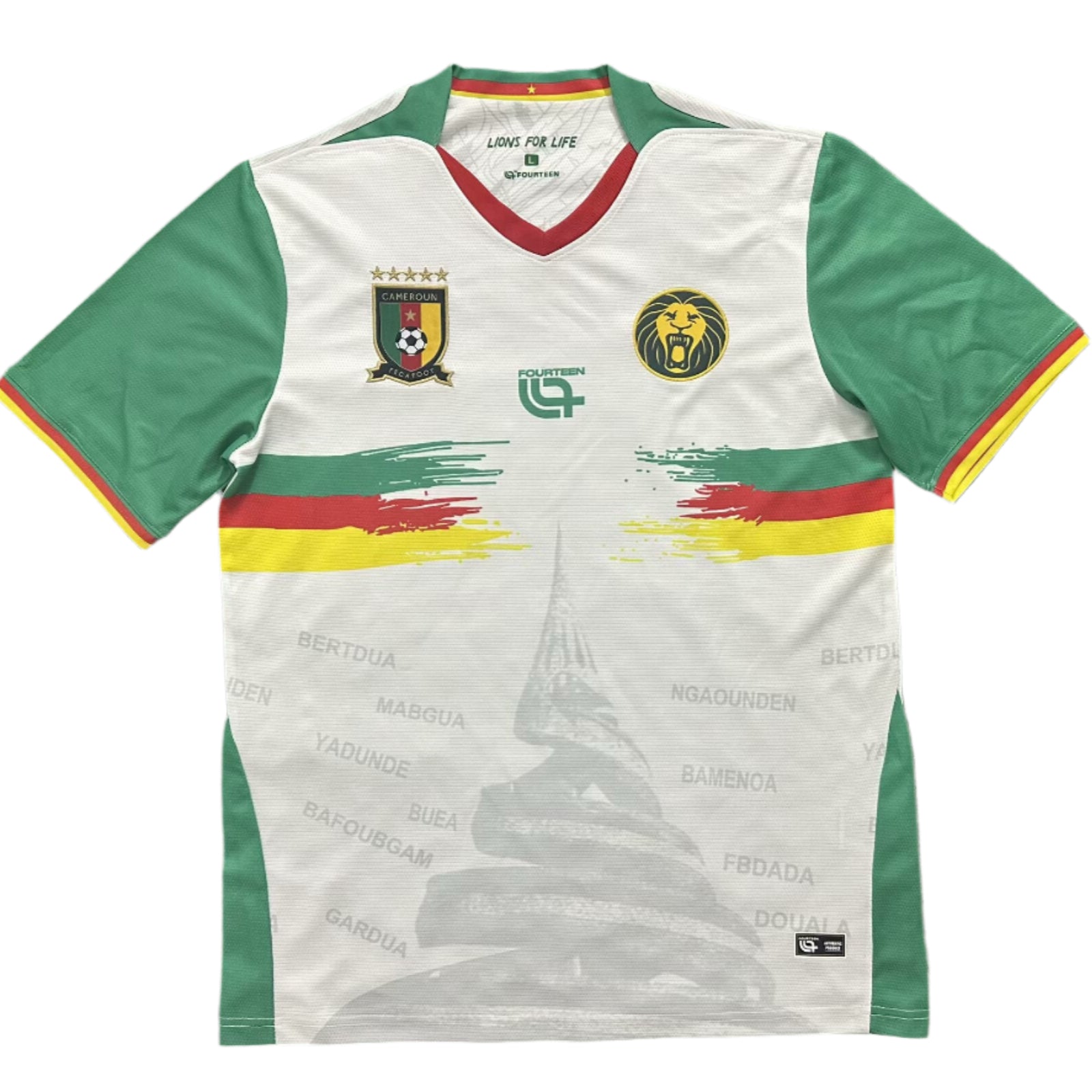 757db22d White soccer jersey with green sleeves and red-yellow trim, featuring Cameroon's crest and a yellow lion badge on the chest.