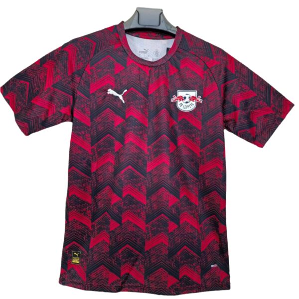 Red and black chevron-patterned RB Leipzig football jersey with Puma logo on the right chest and club crest on the left chest.