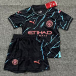Black Manchester City soccer kit: jersey with turquoise lightning patterns, pink Etihad sponsor, crest, and Puma logos with matching black shorts.]