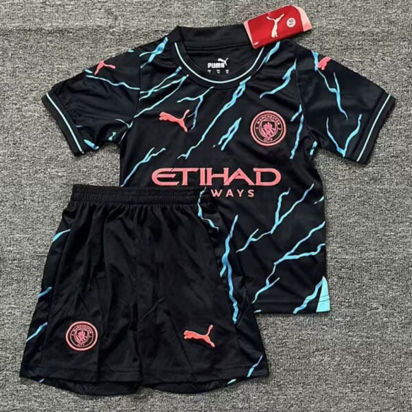 Black Manchester City soccer kit: jersey with turquoise lightning patterns, pink Etihad sponsor, crest, and Puma logos with matching black shorts.]