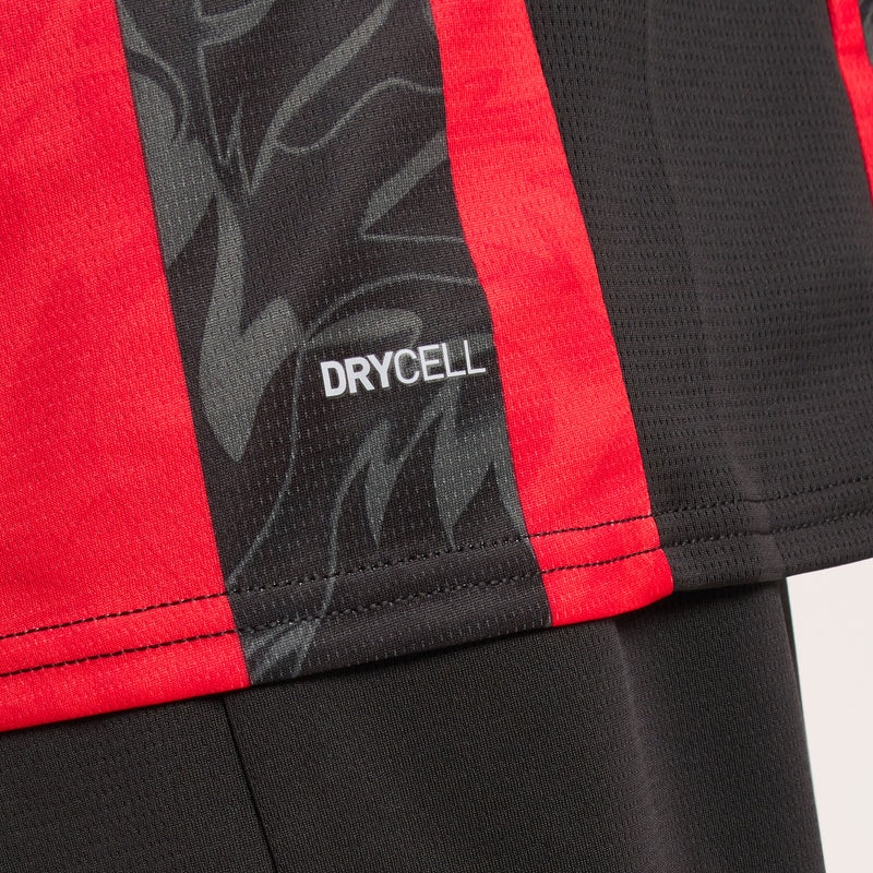 779962-A81_08_800x_d40faff2-0cd0-44cb-93f8-82f30637d3ef | UAE SPORT STORE Close-up of red and black athletic fabric with a 'DRYCELL' label, highlighting moisture-wicking material parallel stripes.