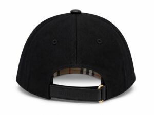 Black baseball cap shown from the back, with a Burberry leather strap and gold buckle; plaid lining peeks through the opening.