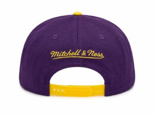 Purple Mitchell & Ness cap viewed from the back with a yellow adjustable strap and embroidered yellow script logo across the crown.