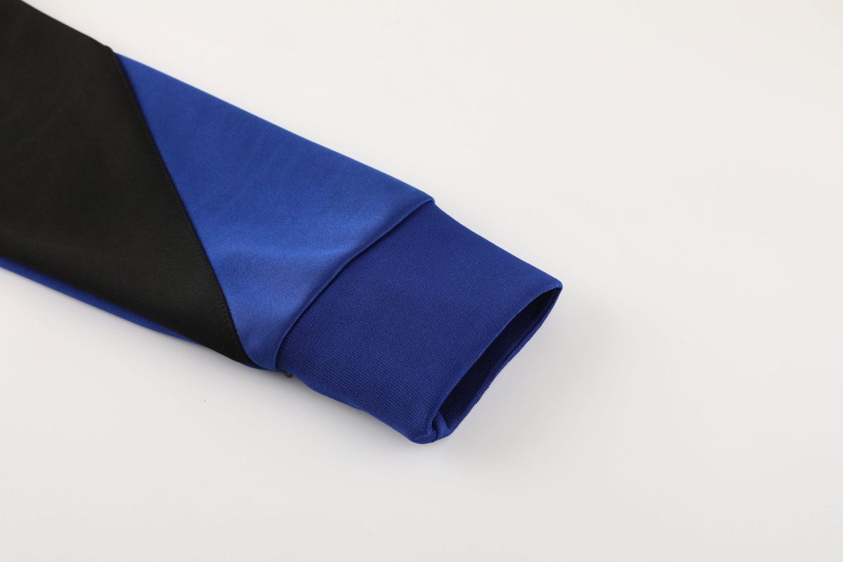 Close-up of a blue and black graduation stole laid on a white background.