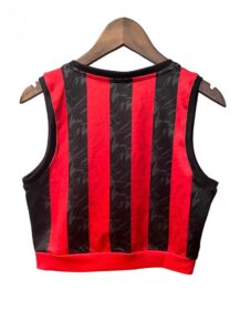 Sleeveless red-and-black striped crop top hanging on a wooden hanger.