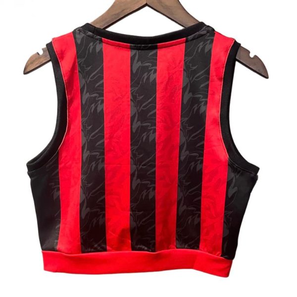 Sleeveless red-and-black striped crop top hanging on a wooden hanger.