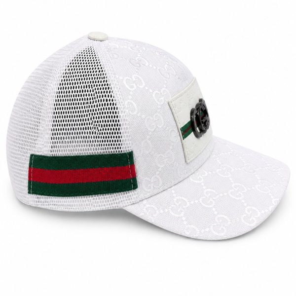 White Gucci baseball cap with a monogram pattern, mesh back, and green-red stripe strap with a metal badge on the front panel.