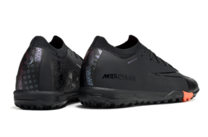 78c0a62f | UAE SPORT STORE Pair of black Nike Mercurial soccer shoes shown from side and back with orange accents on the sole.
