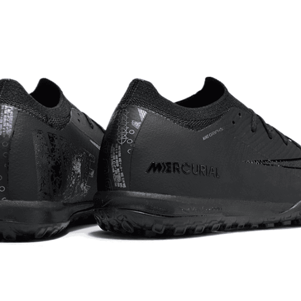 Pair of black Nike Mercurial soccer shoes shown from side and back with orange accents on the sole.
