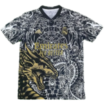 Black-and-white dragon-pattern soccer jersey with gold Emirates logo and DNA-like design, Adidas badge visible on chest.
