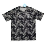 Black and gray geometric-patterned soccer jersey with a Puma logo on the right chest and a circular club crest on the left, tag attached.