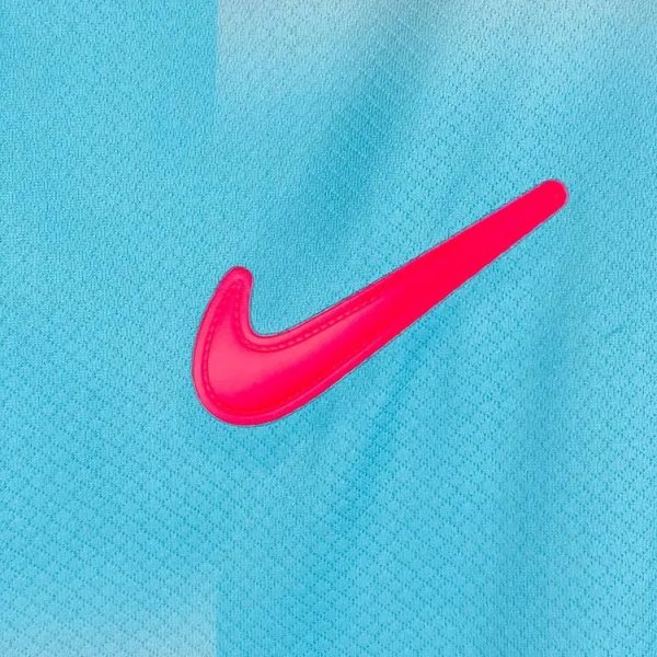 Bright pink Nike swoosh logo on blue fabric.