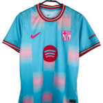 FC Barcelona jersey on a hanger: light blue with pink gradient, with Nike swoosh, Barça crest, and Spotify sponsor logo.