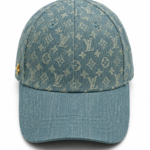 Denim baseball cap with a beige Louis Vuitton monogram pattern and a curved brim.