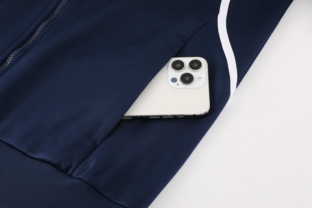 7a640cc4 | UAE SPORT STORE White iPhone with triple-camera system partially visible from a navy jacket pocket