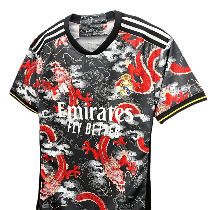 7ae775a0-d619-4915-990a-1ffbc31c4599 | UAE SPORT STORE Real Madrid soccer jersey with red dragon pattern, featuring Emirates Fly Better text and club crest on a black background with white stripes on the shoulders.