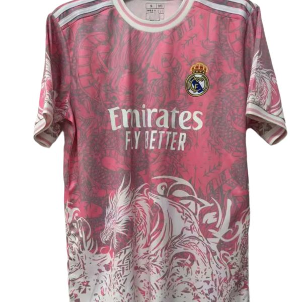 Pink Real Madrid football jersey on a hanger, with the Emirates Fly Better sponsor and club crest visible.