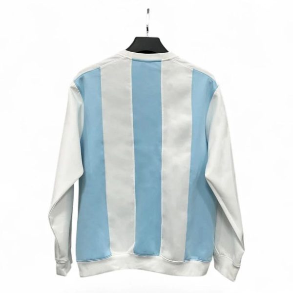 Back view of a light blue and white vertical striped jacket hanging on a black hanger.