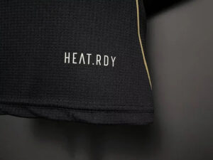 Close-up of black fabric with the white 'HEAT.RDY' branding along a seam.