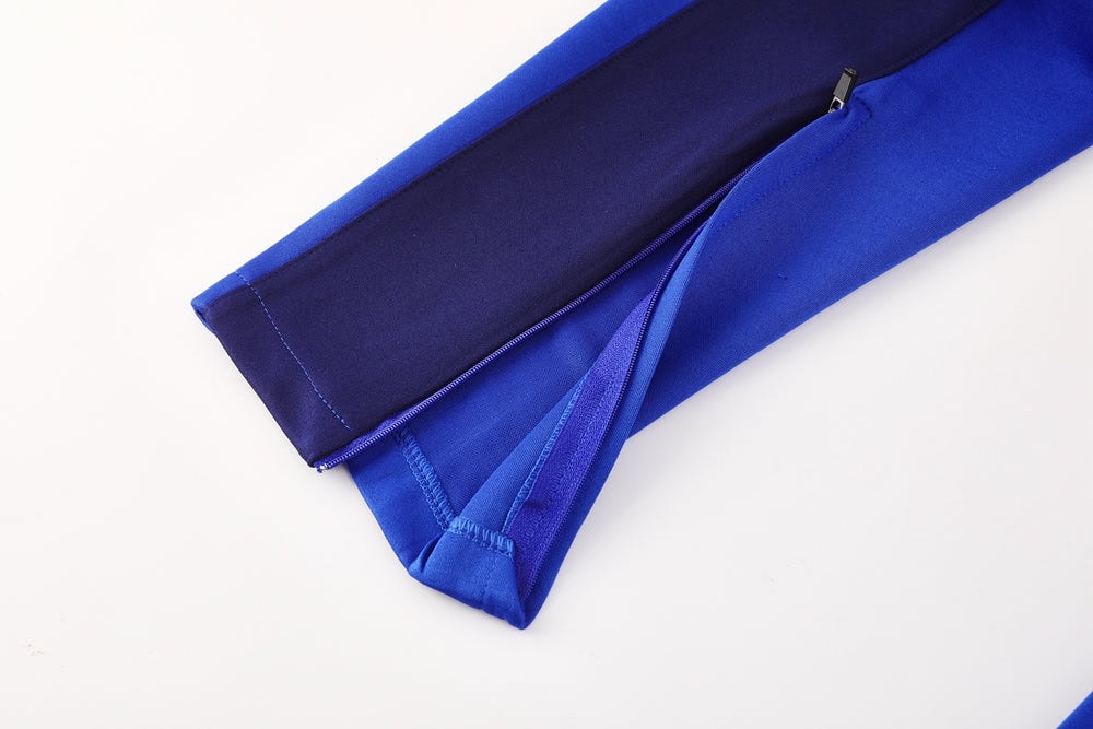 7cae75cc | UAE SPORT STORE Blue zippered fabric case lying on a white background, partially unzipped.