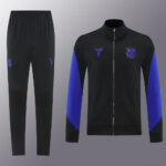 Black training tracksuit with royal blue panels on the sleeves; jacket features a zipper, club crest and a team logo on the chest, matching black pants with small blue emblems.