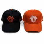 Heritage Crest Luxury Cap with embroidered logo in black and orange.