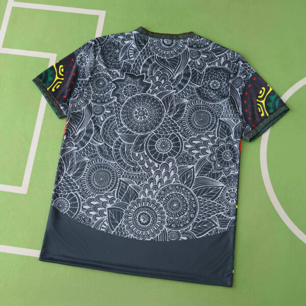 Dark fabric with dense white mandala floral pattern spread on a green background.