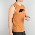 Person wearing an orange Nike sleeveless shirt, shown from the chest up against a light gray background.